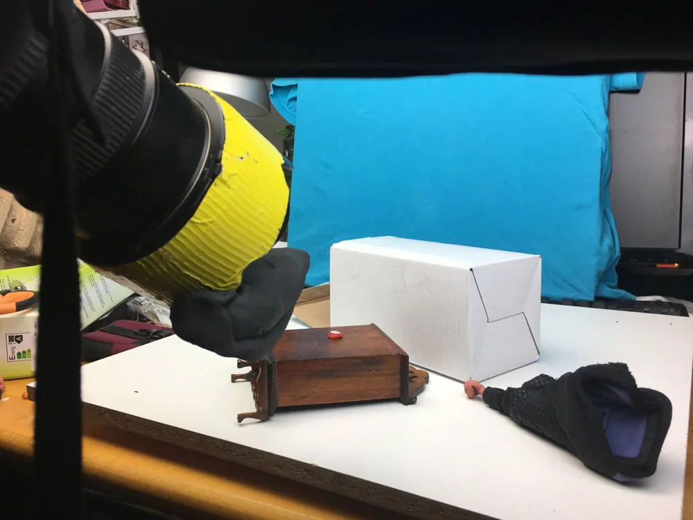 Picture of the camera and a cupboard lying on its side and used as a table.